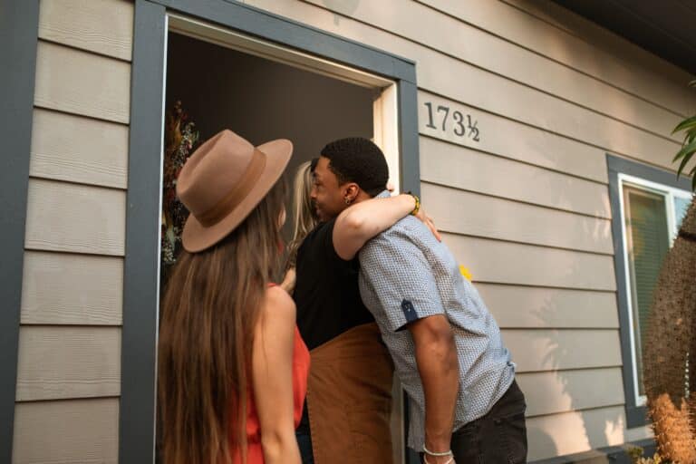 Warm doorway welcome, host and guests