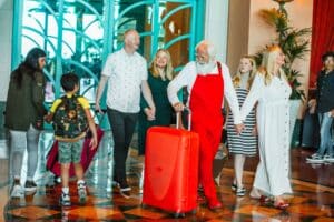 Family arriving with luggage, all smiles
