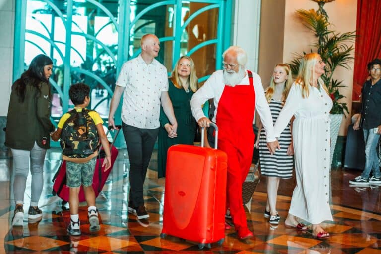 Family arriving with luggage, all smiles