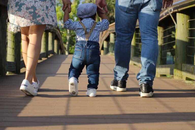Family walking on a sunny Florida boardwalk