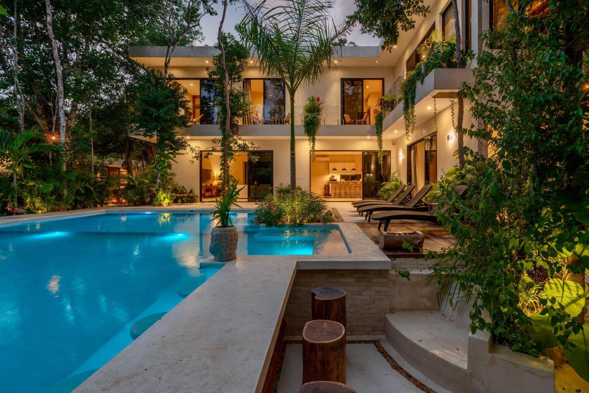 Private villa pool lit up in the evening