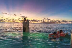 Family by the pool at sunset